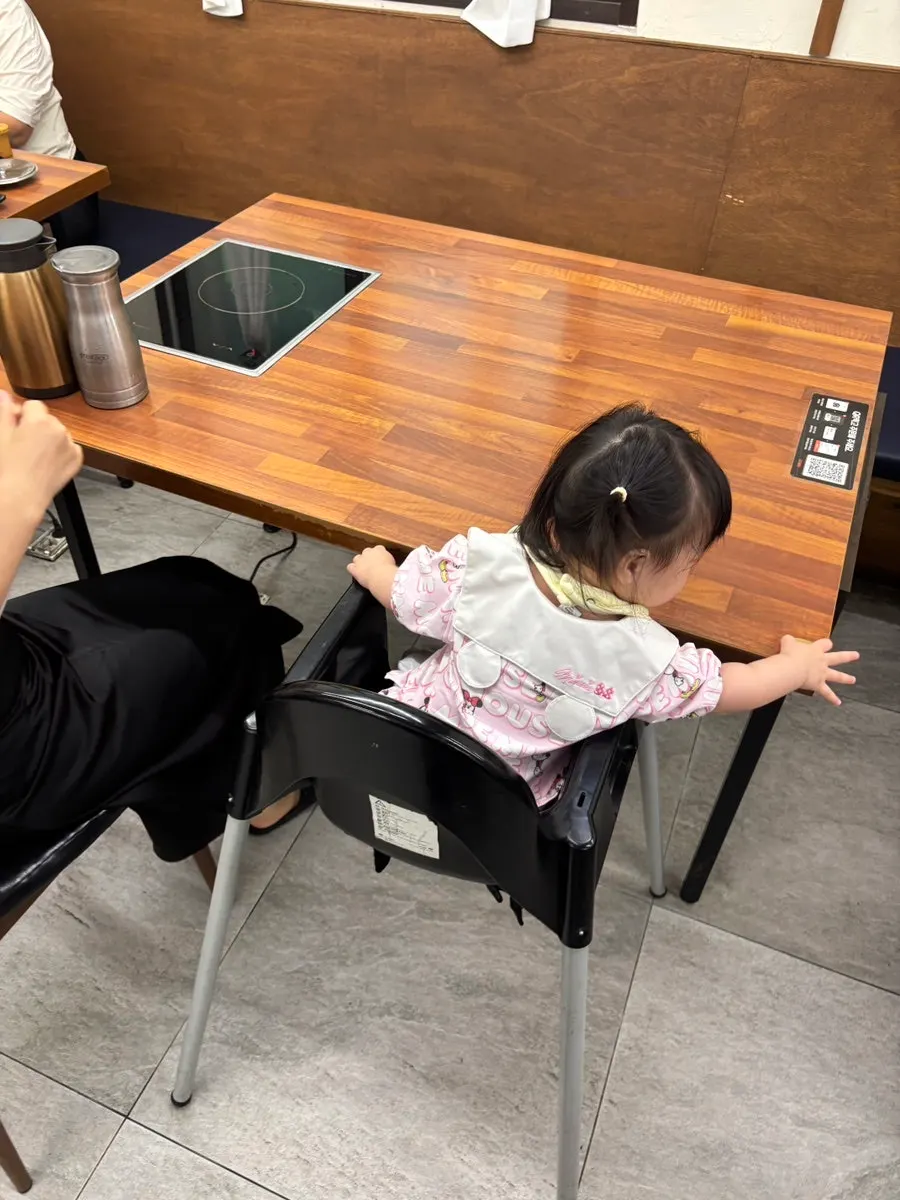Table with a baby chair set up at Deulkkot Ssambap