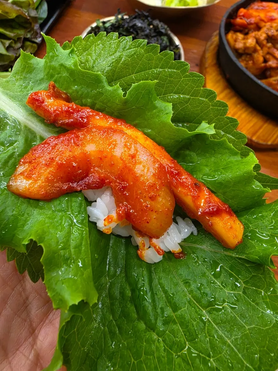 A wrap bite topped with squid stir-fry