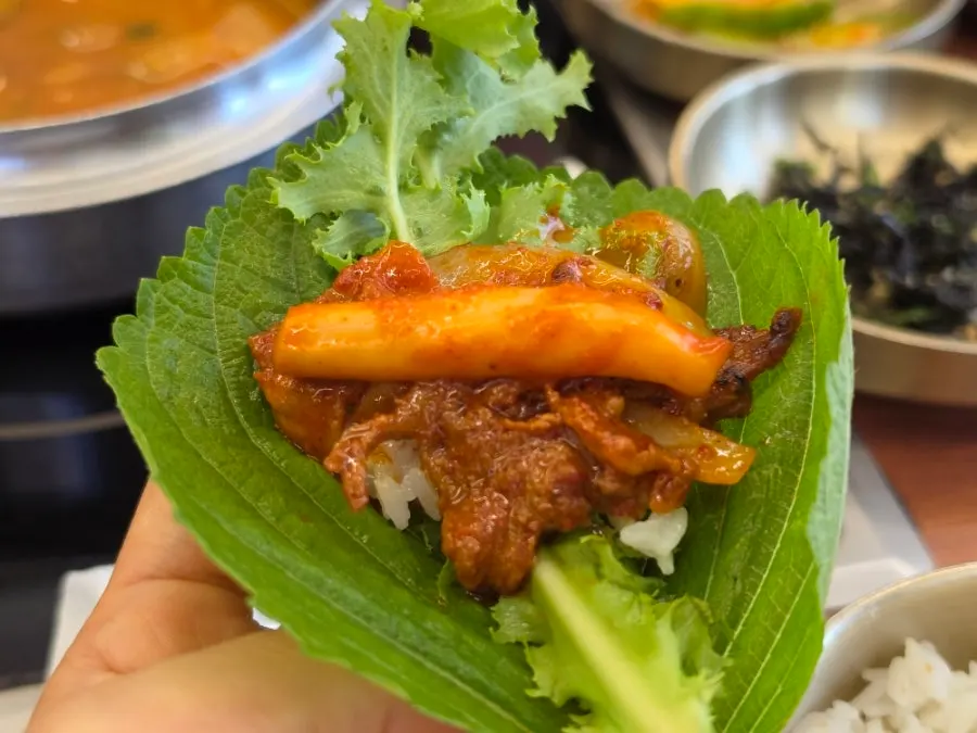 A wrap topped with pork and squid stir-fry