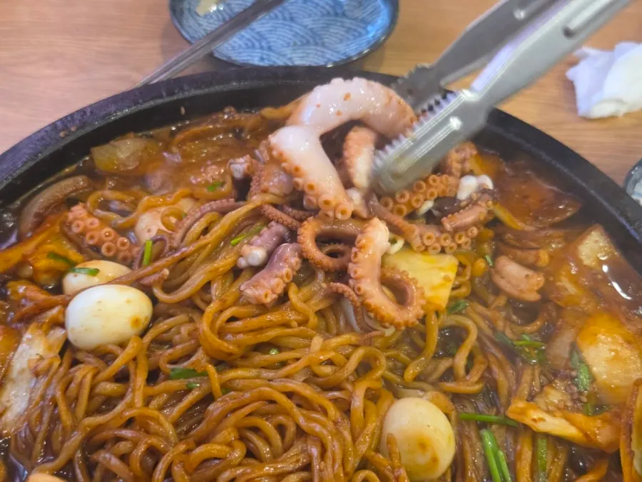 Noodles lifted gently from the nurungji stone-plate jjajang