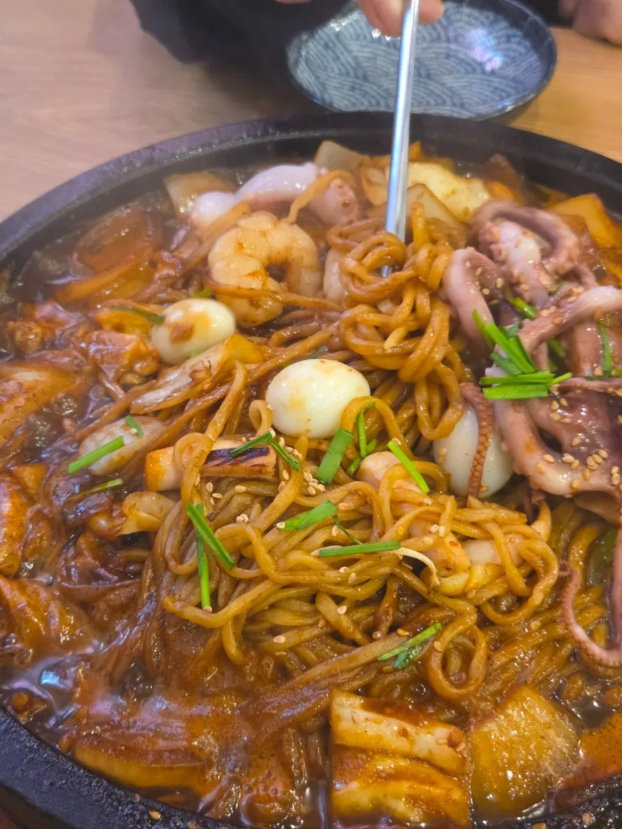 Stone-plate jjajang packed with octopus and shrimp toppings