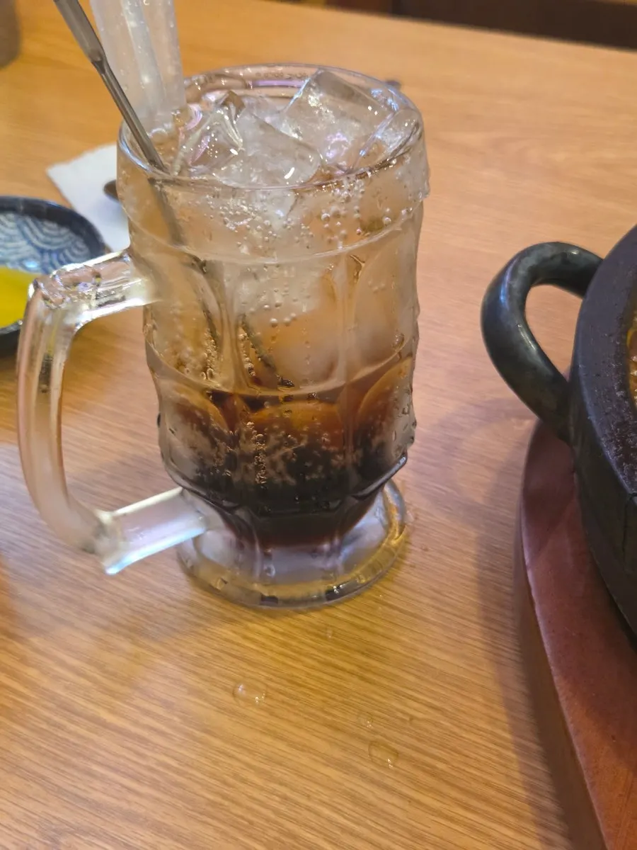A glass of plum ade served alongside the meal