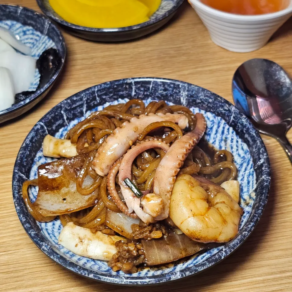 A plate of jajangmyeon mixed with noodles and seafood