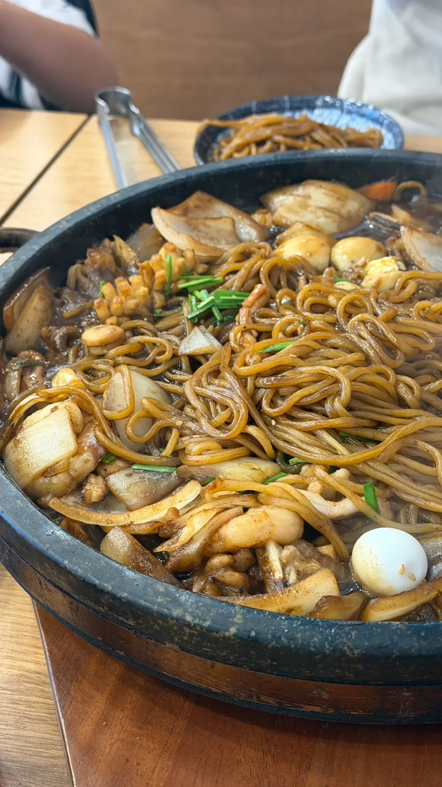 Jajang sauce and noodles bubbling on the stone plate