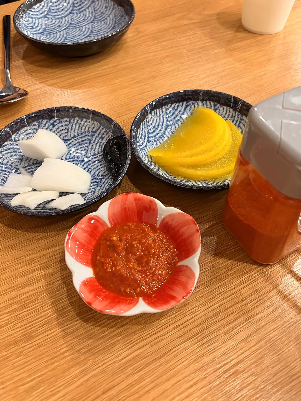 Separate spicy sauce served alongside the stone-plate dish