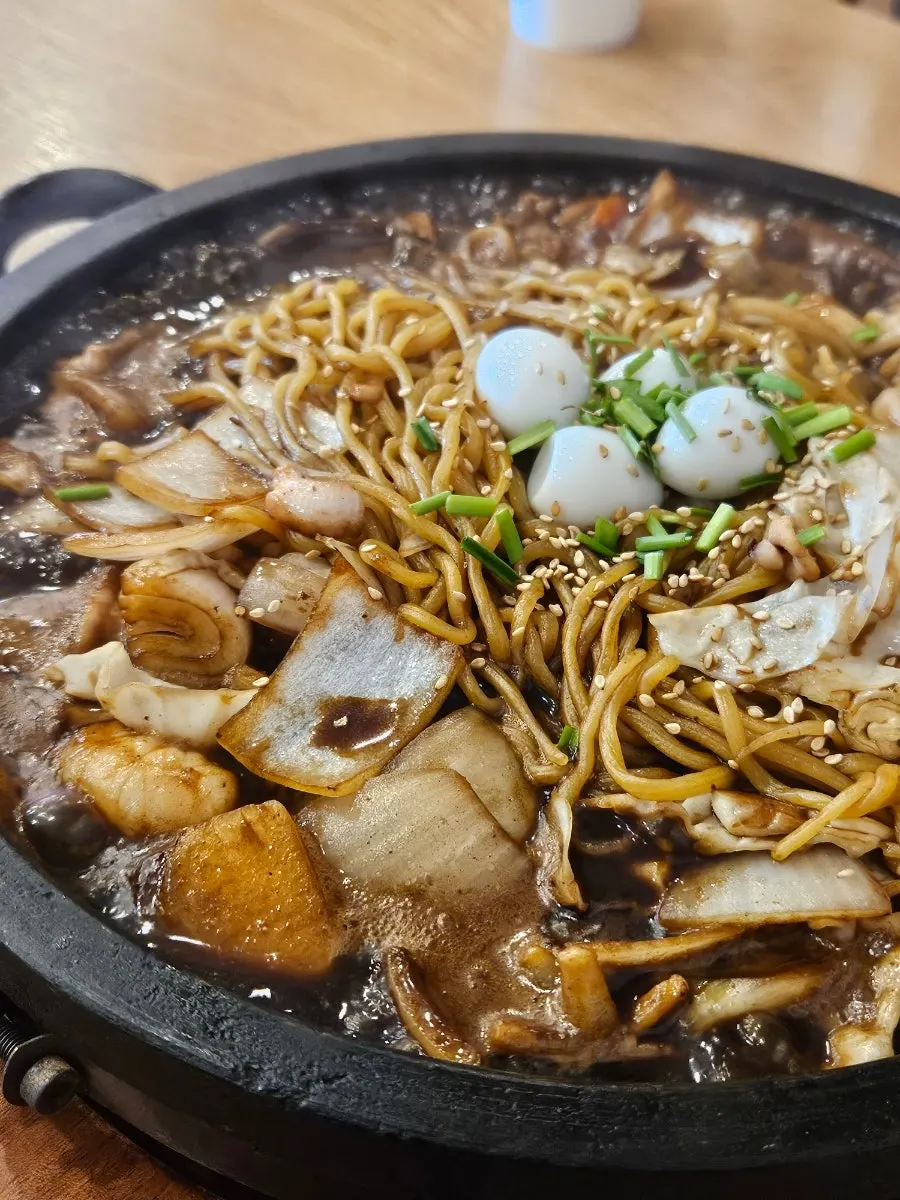 Stone-plate jajang with onion, seafood, and quail eggs
