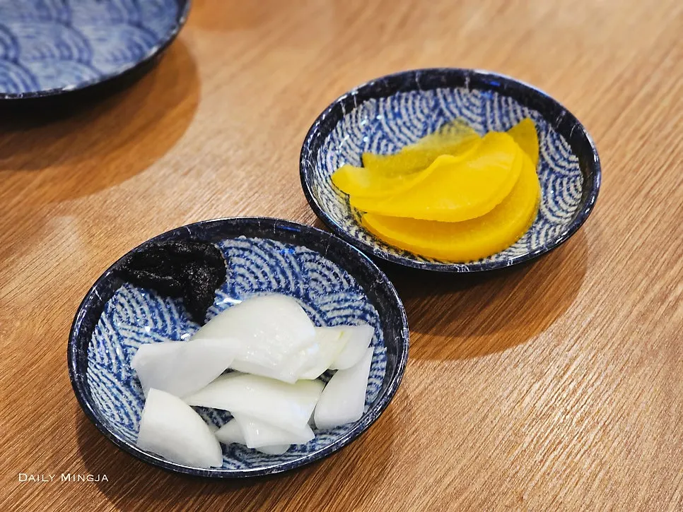 A plate with danmuji and onion side dishes