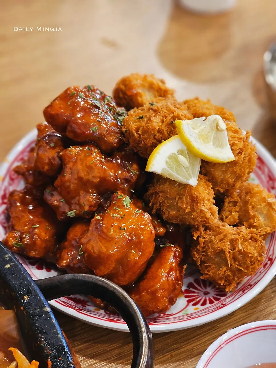 A plate of seasoned boneless chicken and fried pork cutlet