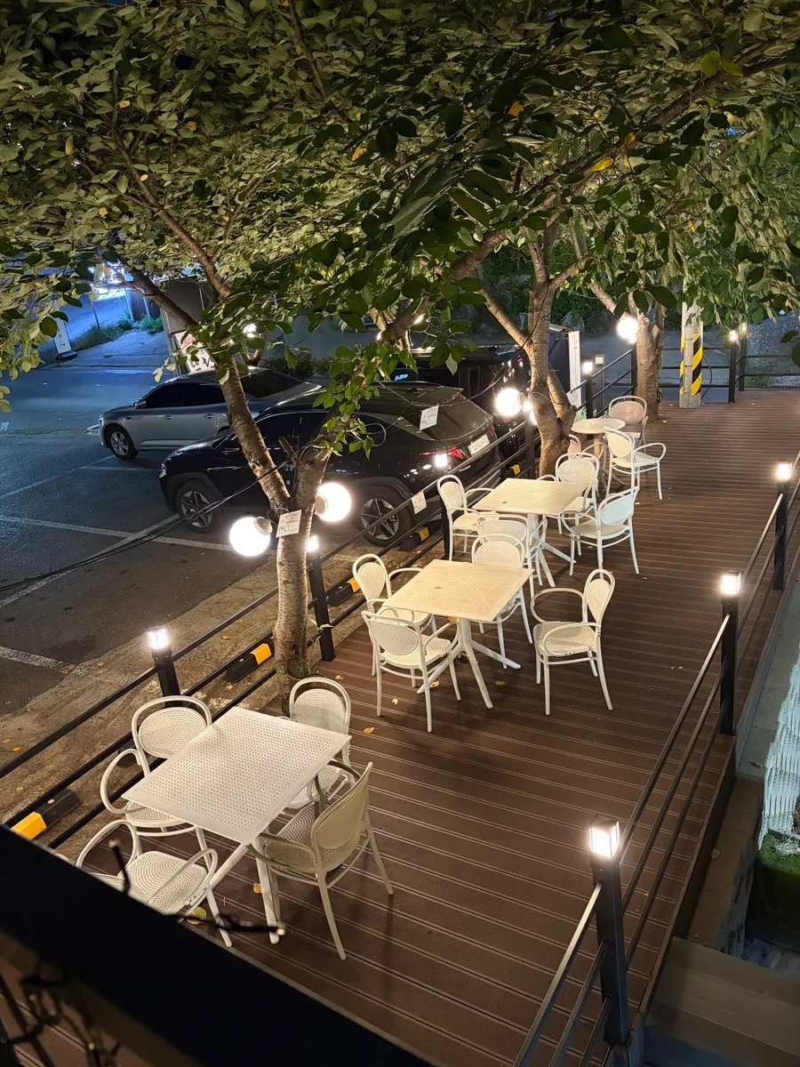 Full view of Fruit Forest's terrace with white tables