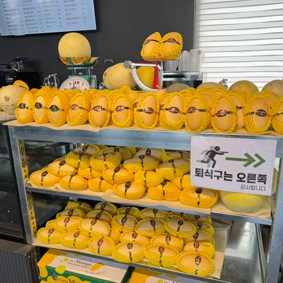Store corner displaying fresh fruit and cup fruit