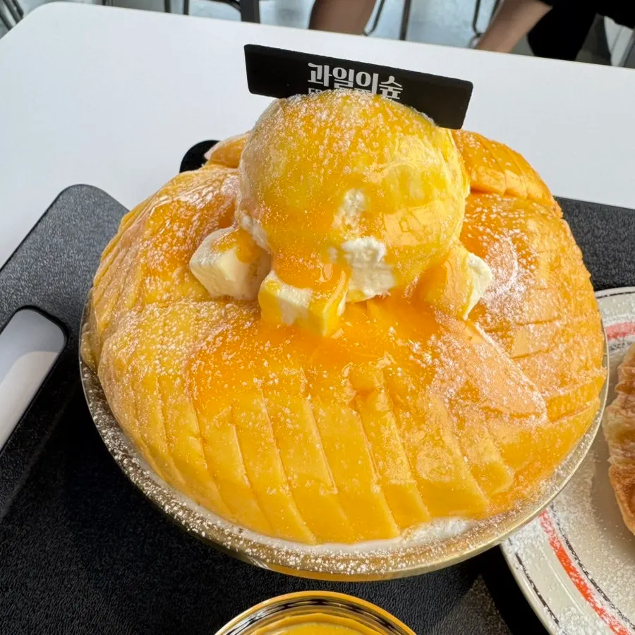 Yellow fresh mango piled on top of the snow ice