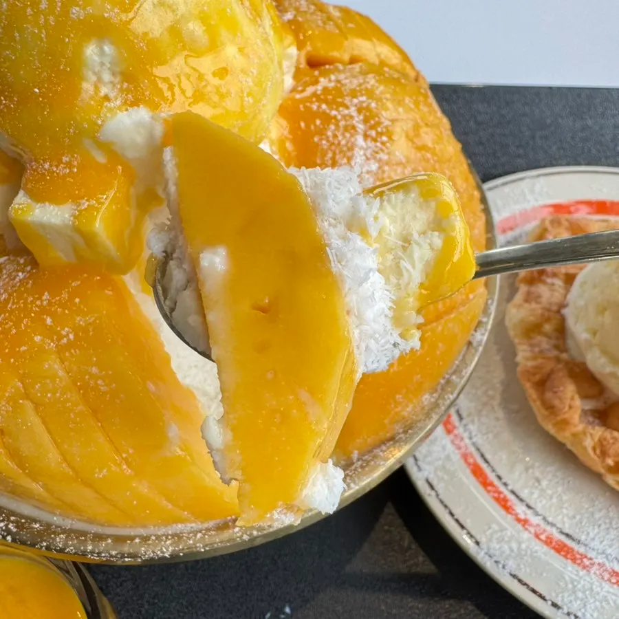 A spoonful of well-ripened fresh mango flesh