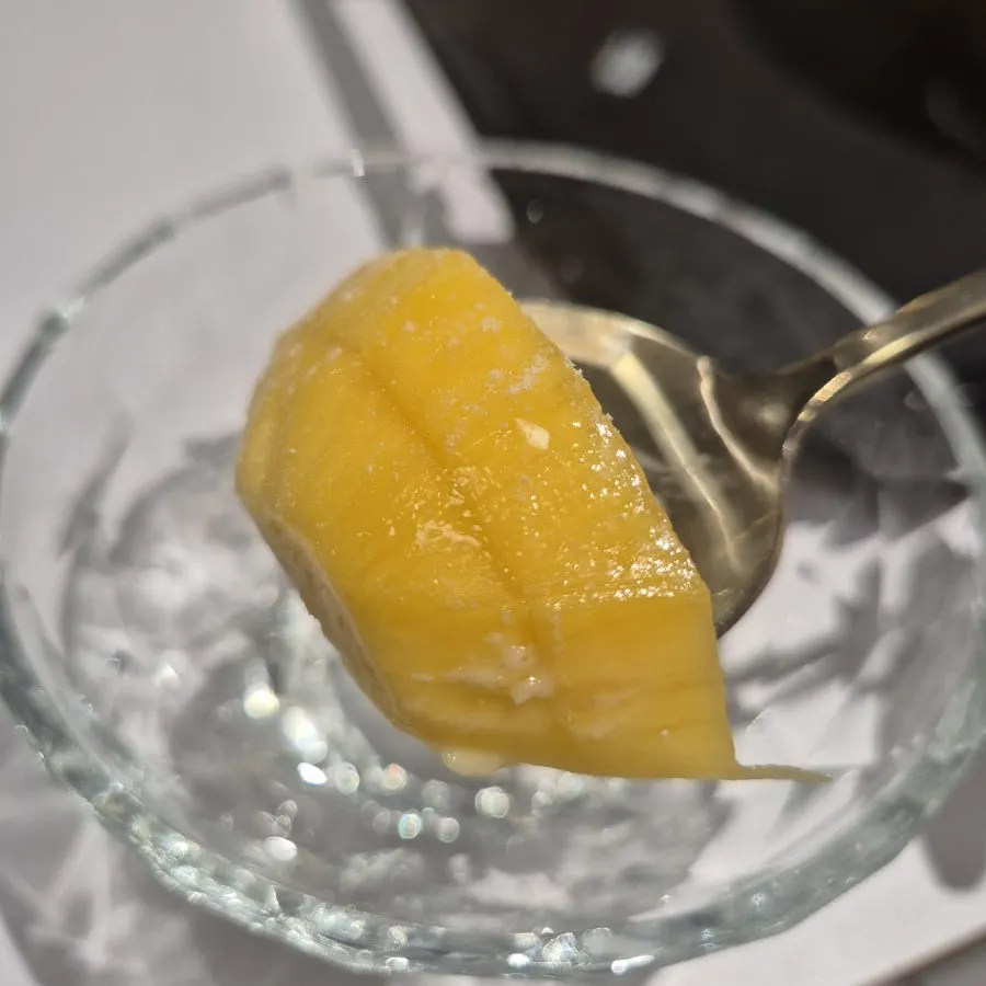 Ripened fresh mango stacked on top of the bingsu