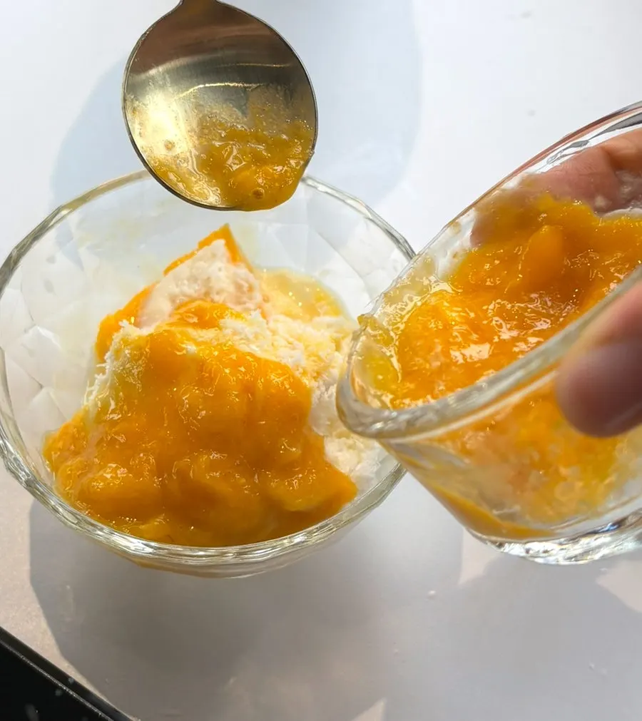 Fresh mango and milk-ice bingsu portioned onto a side plate