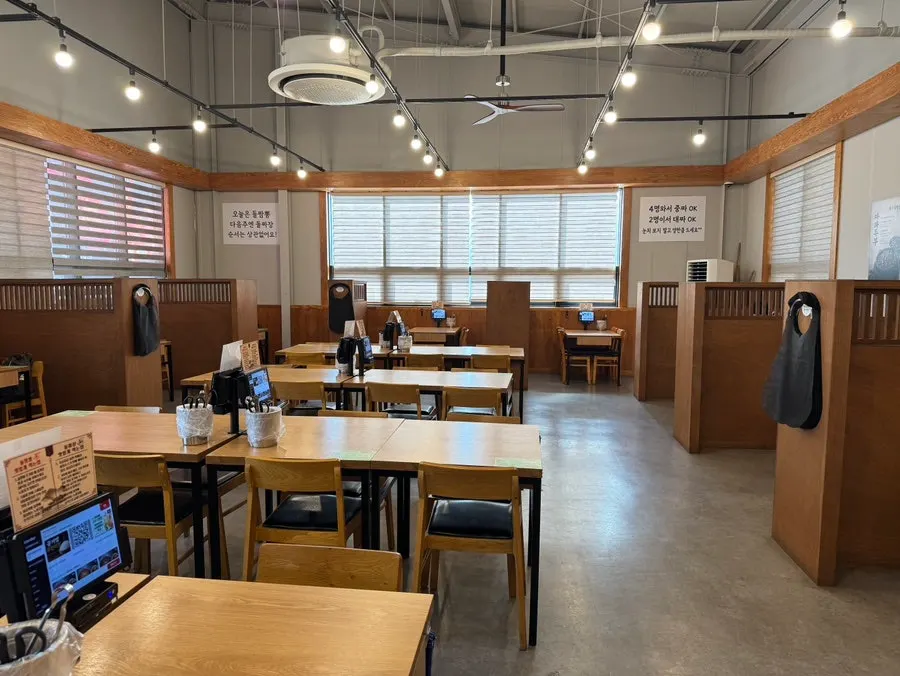Dining hall with wide table spacing at Dolpanseok Jjamppong Paju Simhaksan Branch