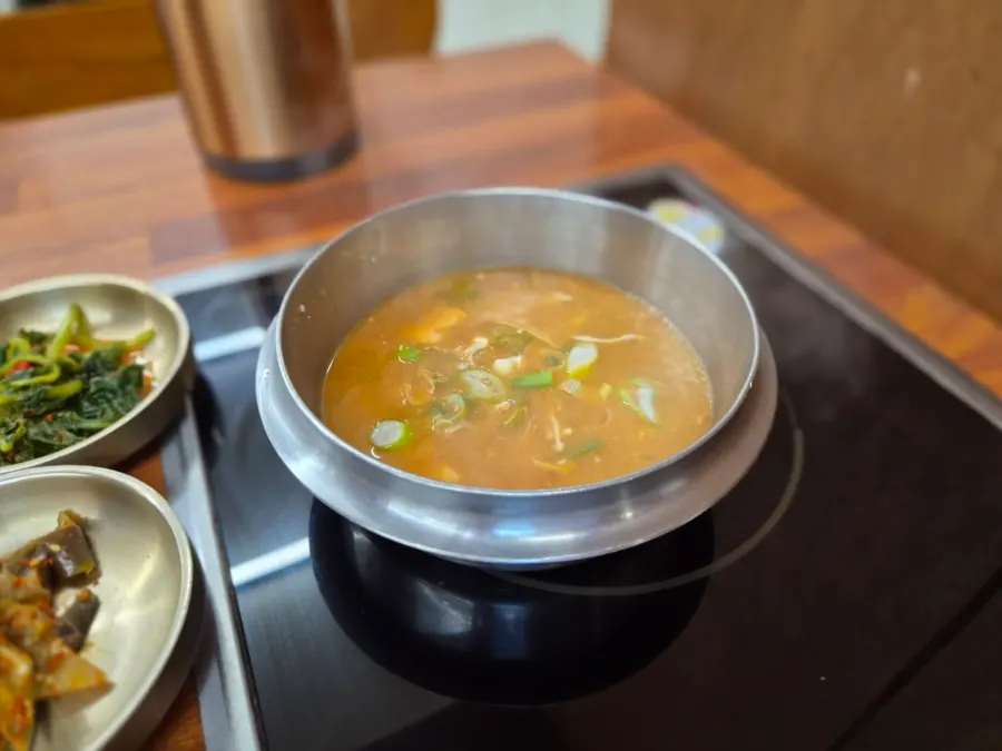 Soybean paste stew simmering on an induction burner