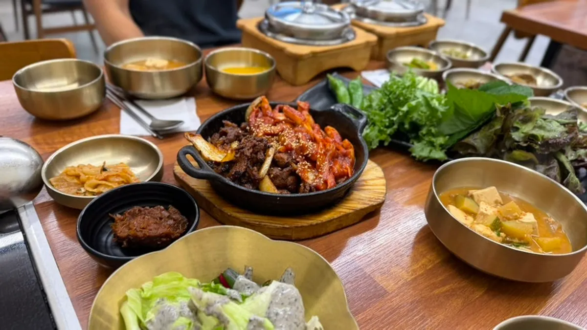 Deuljeongsik set with pork stir-fry, squid stir-fry, and stone-pot rice