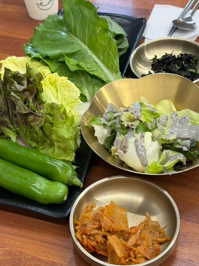 Salad and stir-fried kimchi among the side dishes