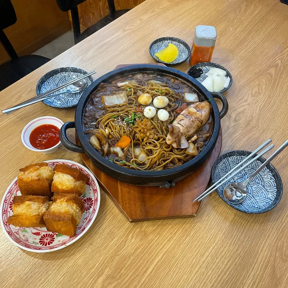 Stone jjajang sauce bubbling on the hot stone plate
