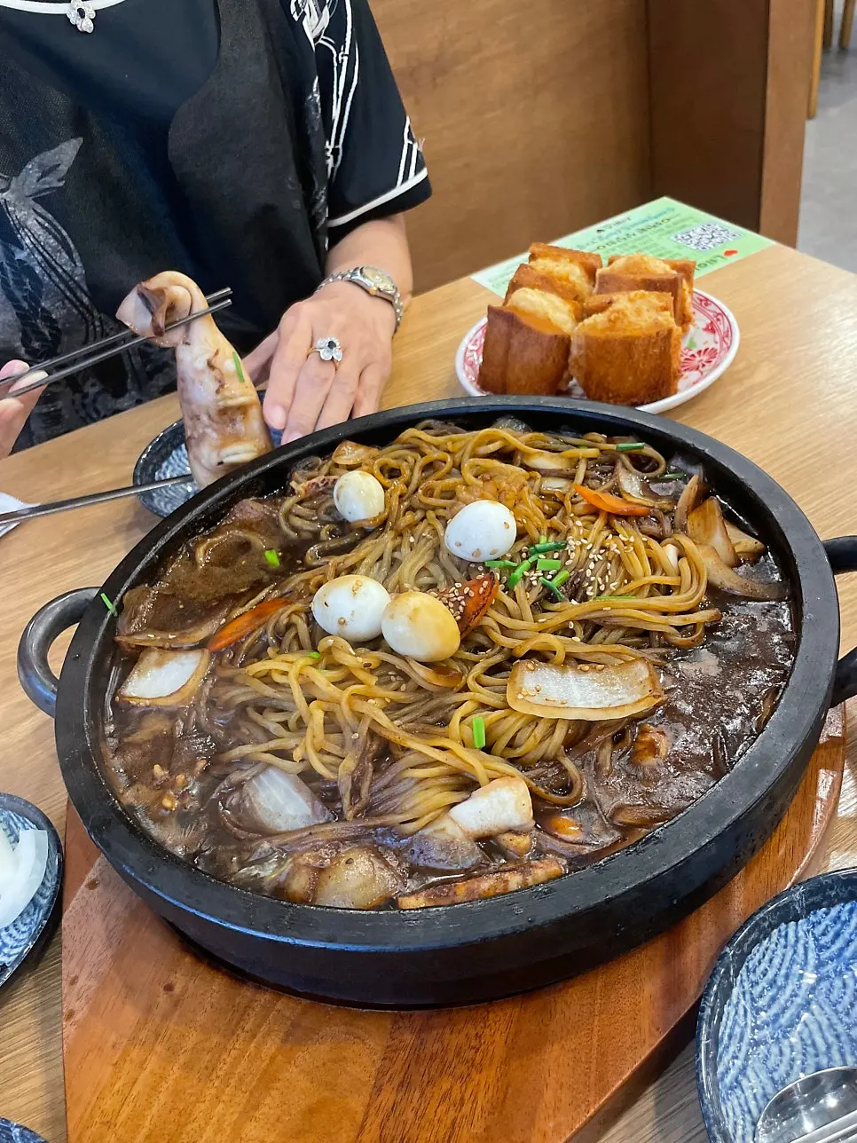 Mixing the jjajang sauce into the noodles