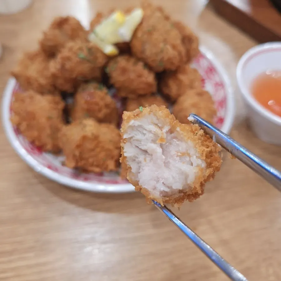 A piece of handmade pork soup dipped in sauce