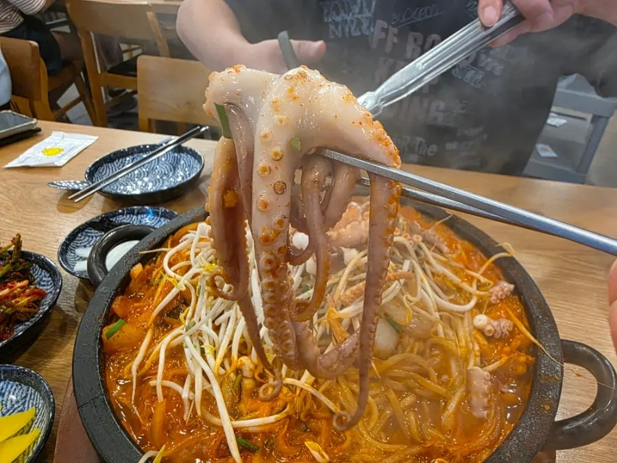 Medium stone jjamppong piled with bean sprouts and a whole octopus
