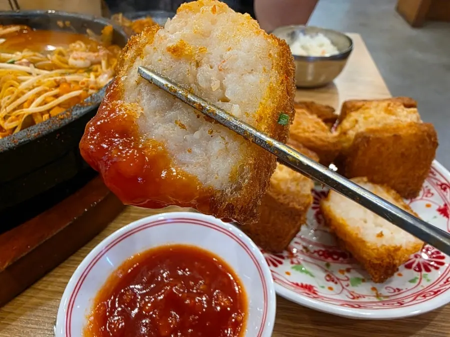 A piece of tungbosha dipped in sauce