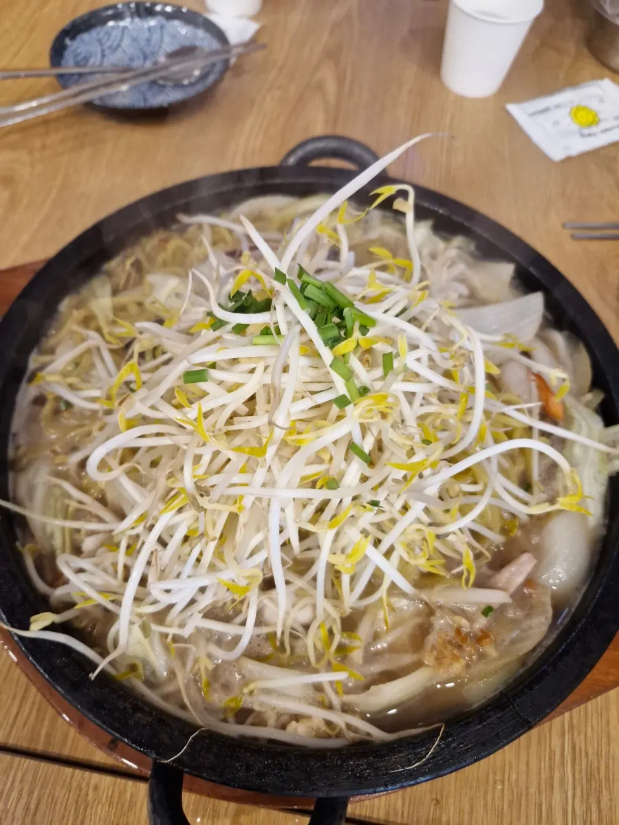 White jjamppong noodles and seafood mixed on the stone plate