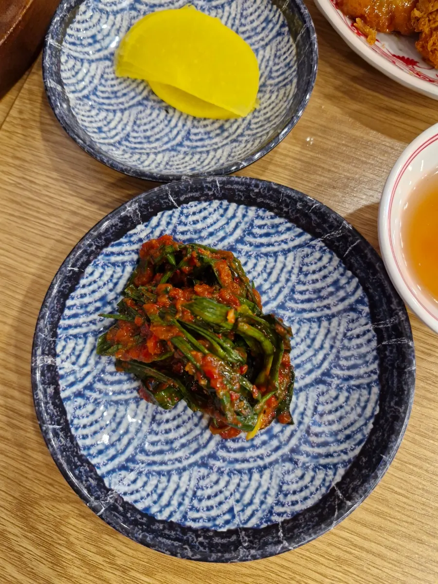 A piece of pork cutlet with lemon and sauce