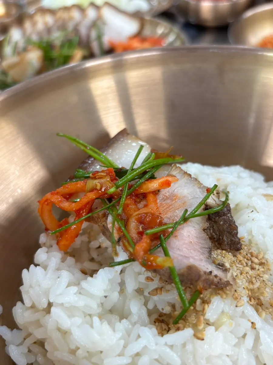 A piece of five-layer pork belly suyuk at Cheonje Guksu