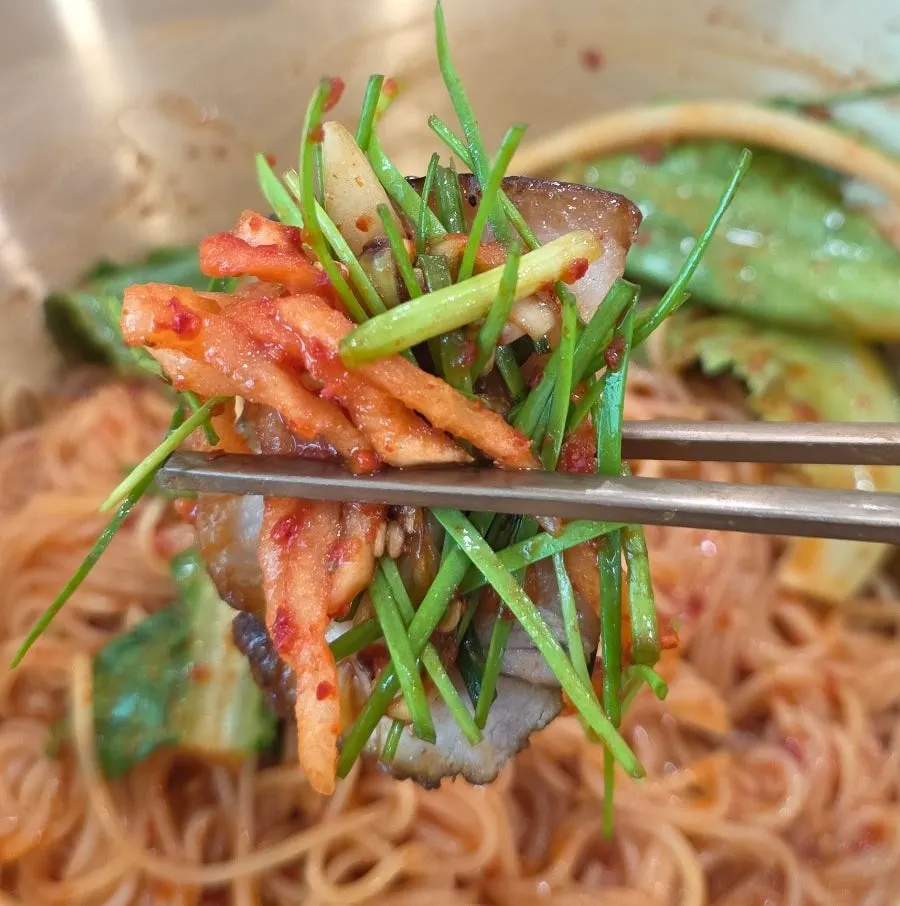 A piece of suyuk topped with vegetable salad