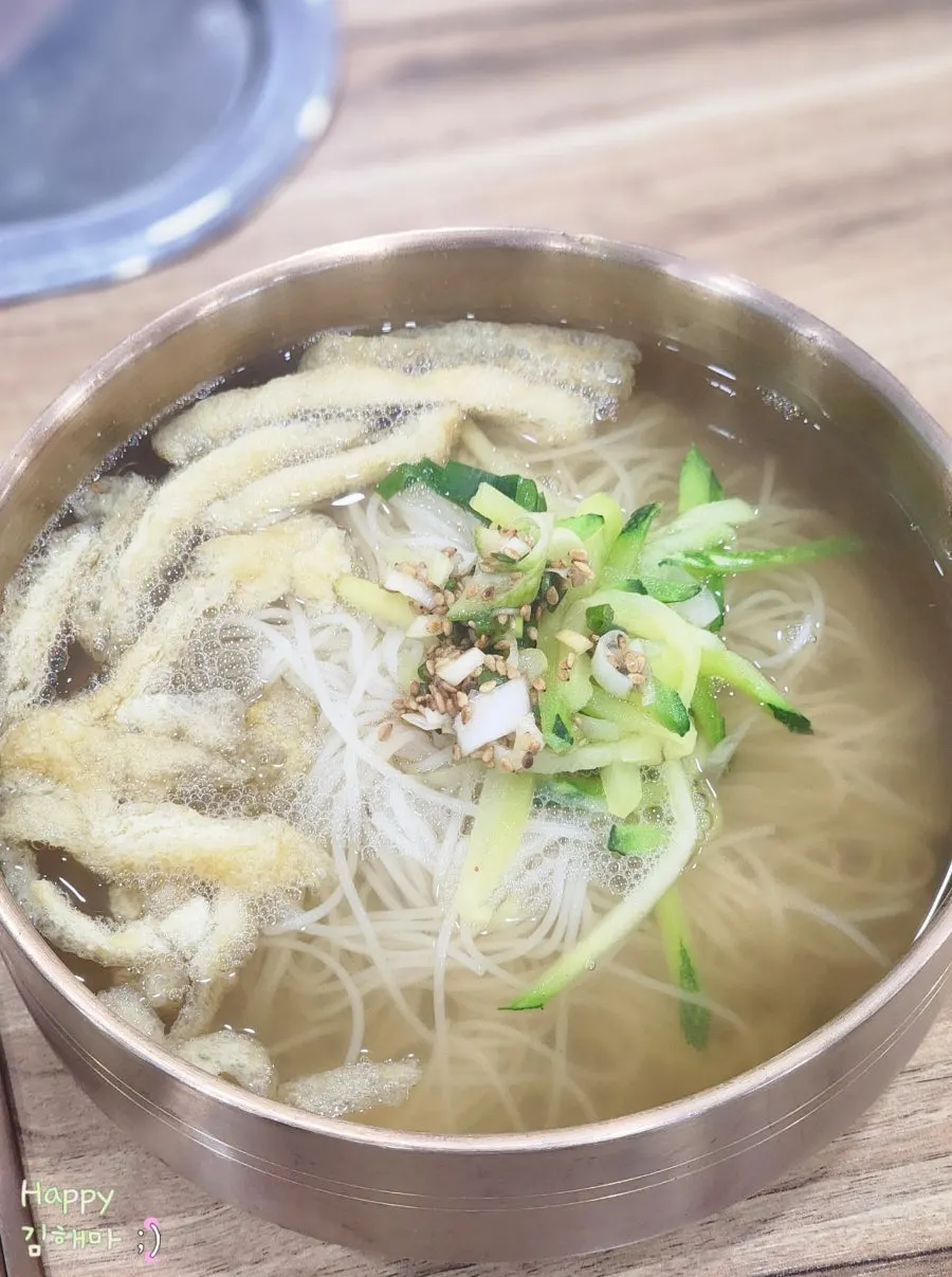 Janchi guksu topped with fried tofu and zucchini garnish