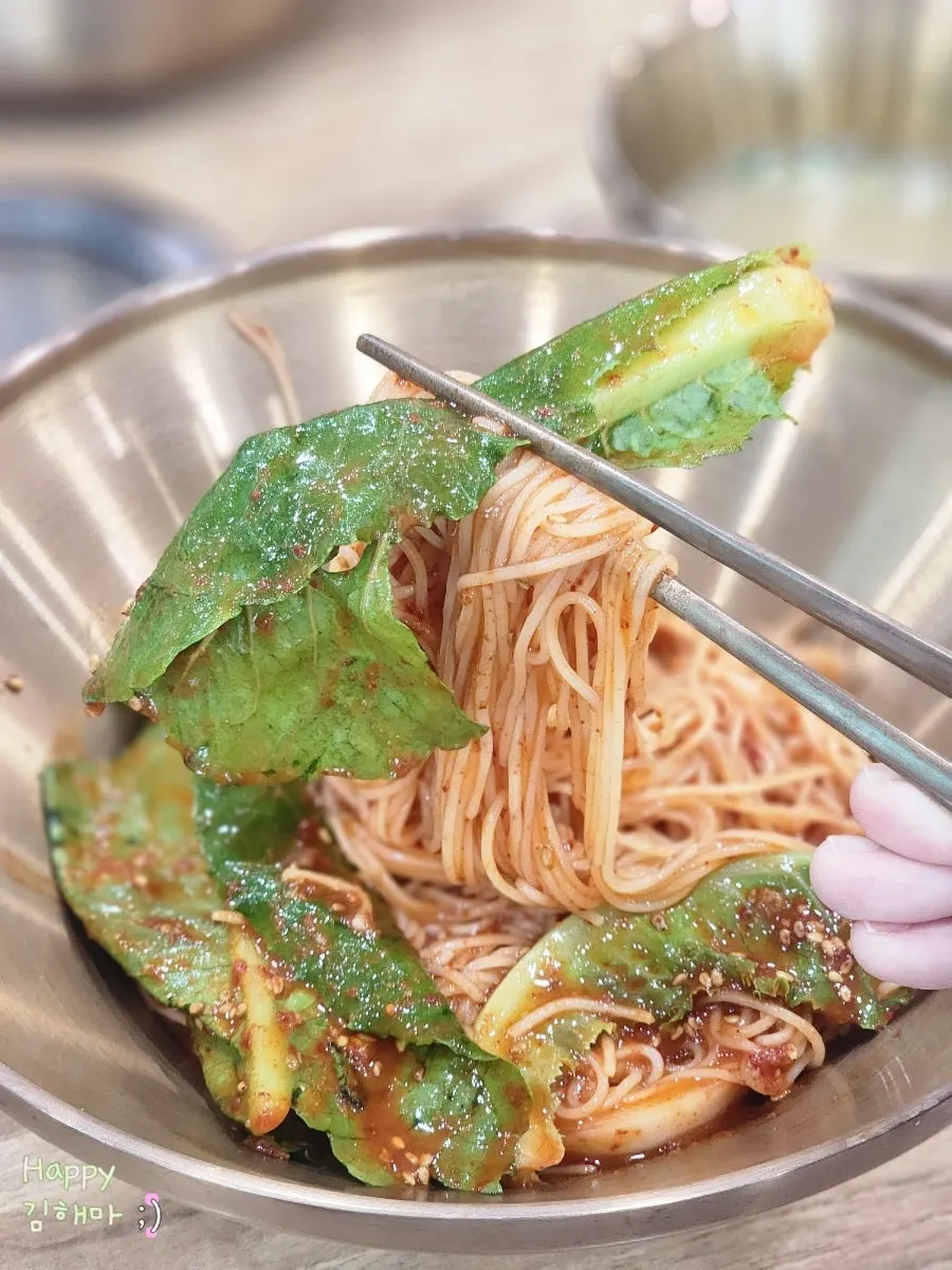 Mixing and lifting up the bibim guksu noodles