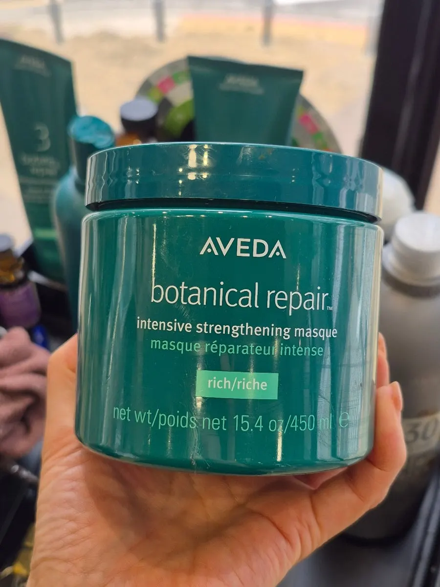 Aveda product lineup neatly arranged on display shelves