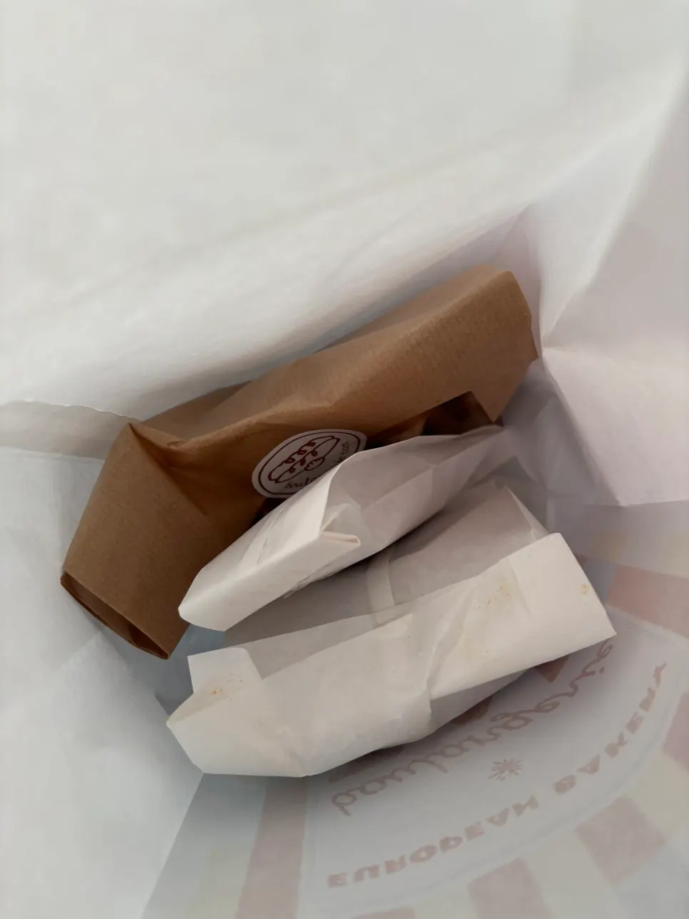 Bag of bread packed for takeout from Boulangerie Tan