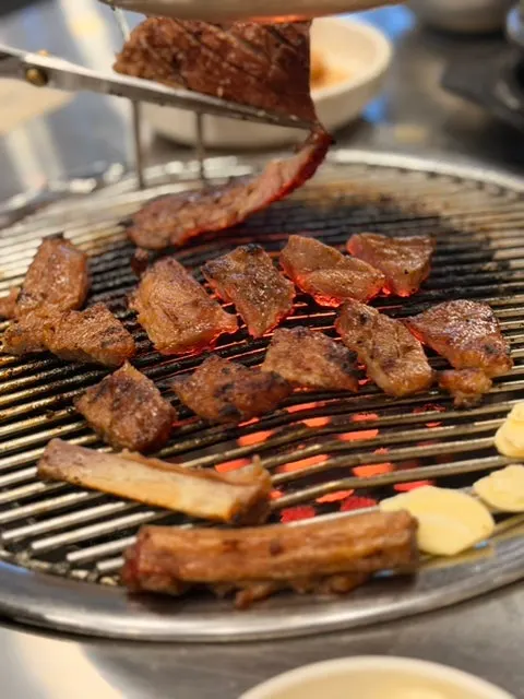 Meat cooking over the charcoal fire