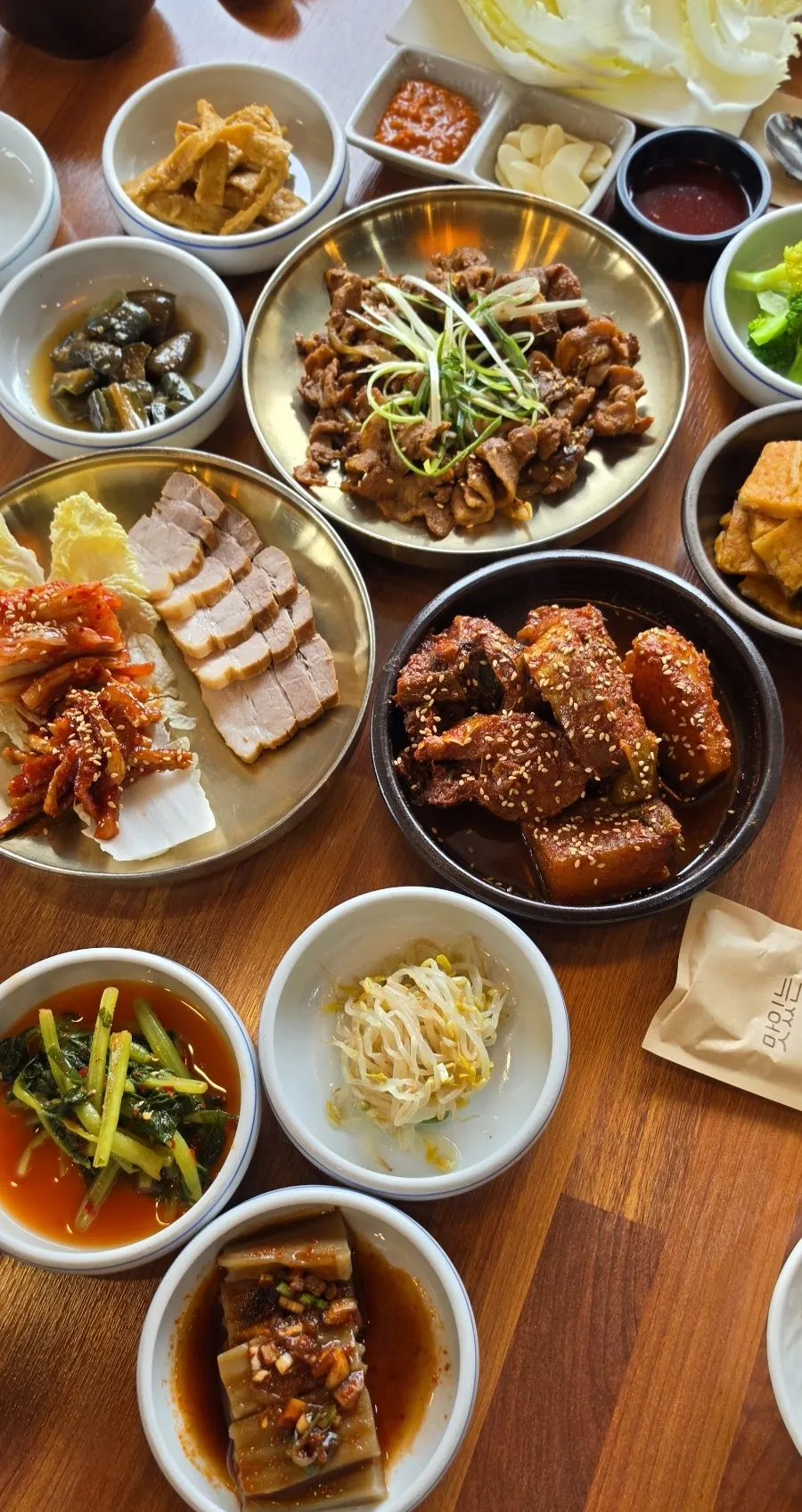 Hanjeongsik-style table with bossam, braised kodari, and pork bulgogi
