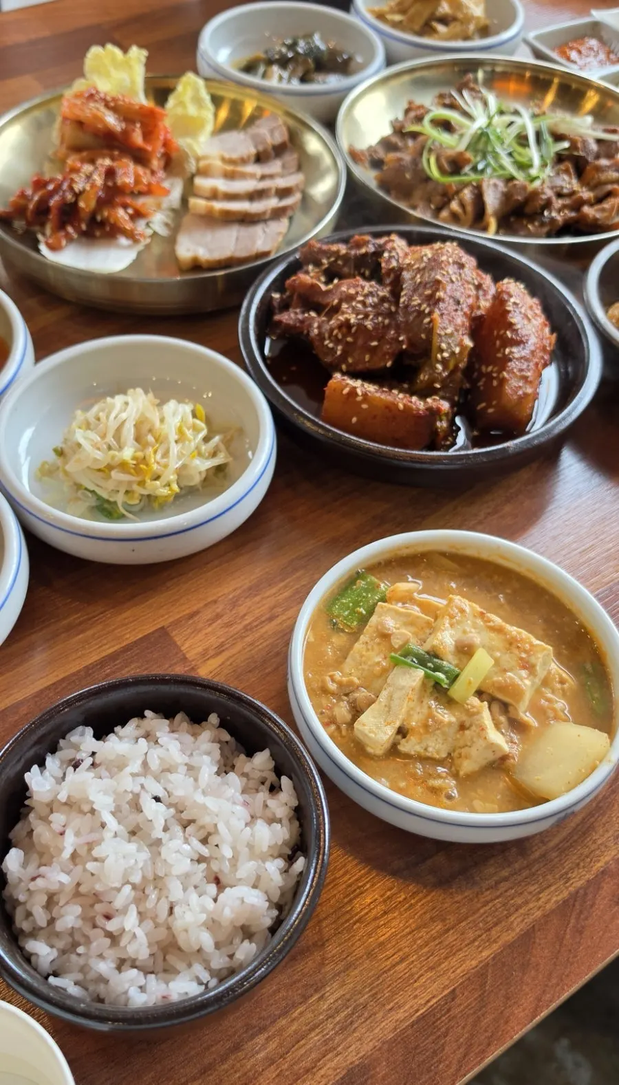 A table loaded with home-style dishes at Eomma-ui Ttuksim