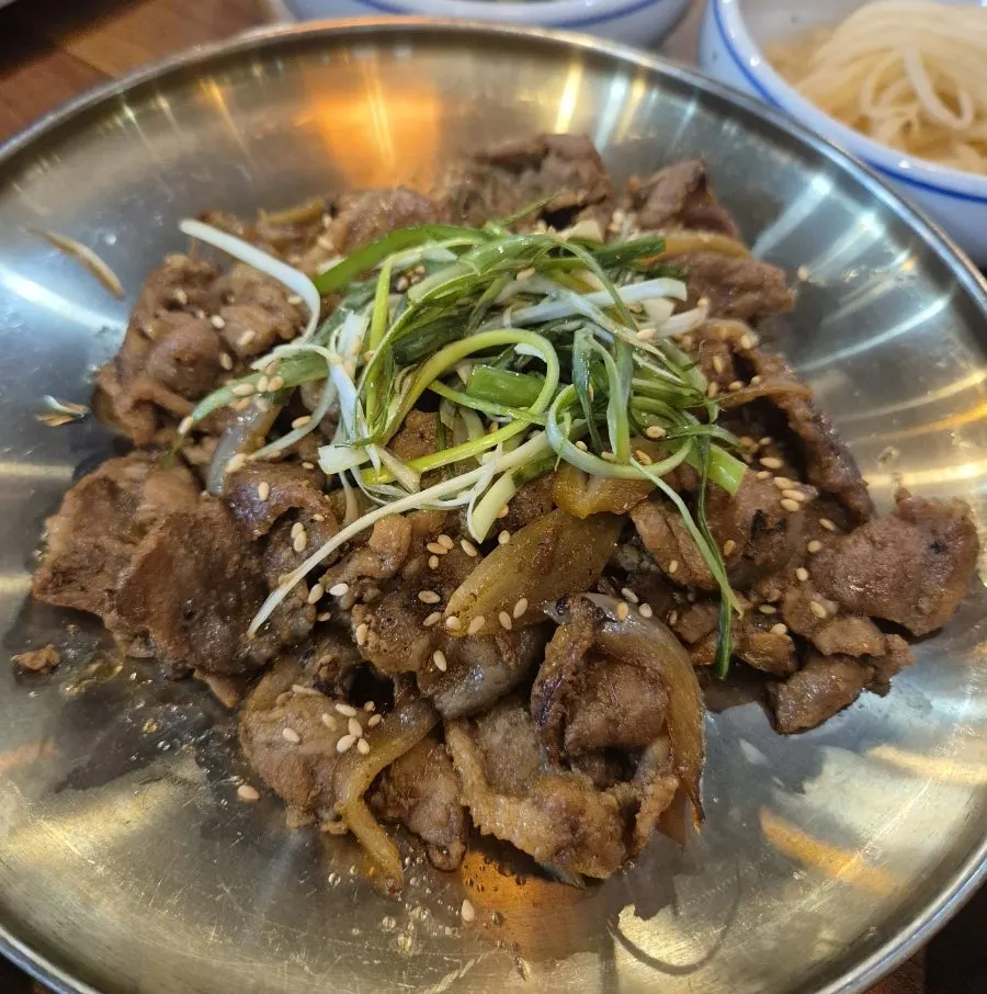 The rich doenjang jjigae broth with plenty of ingredients