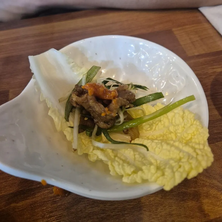 A bite of pork bulgogi with rice