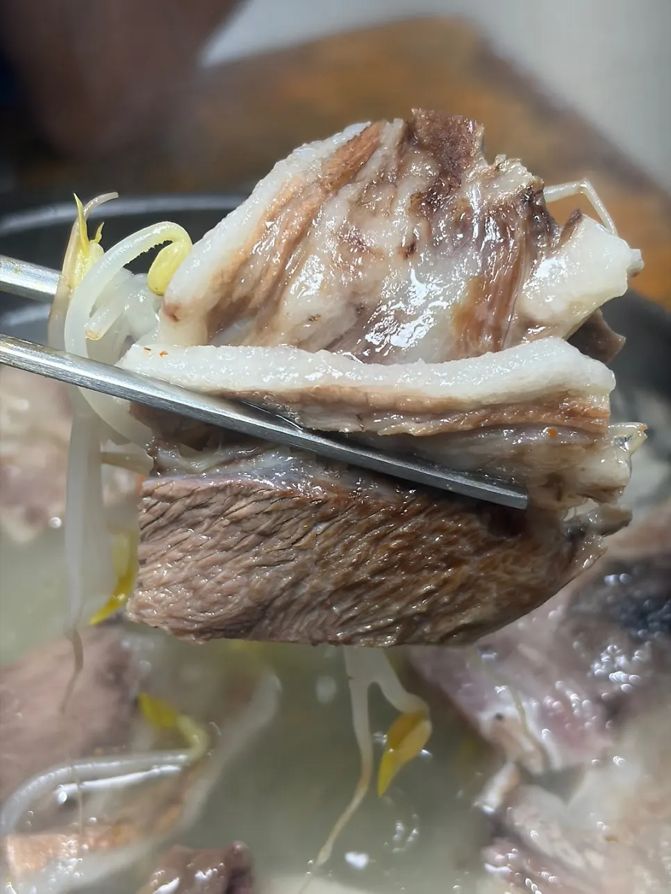 A slice of suyuk with fat and lean meat attached