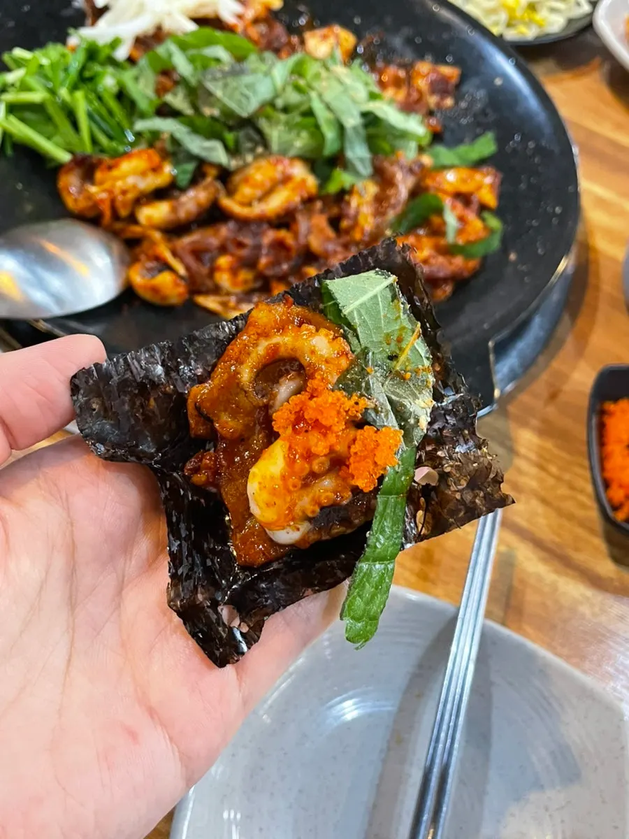 Griddle-stir-fried Jikhwa Bul Jjuksam with a smoky char