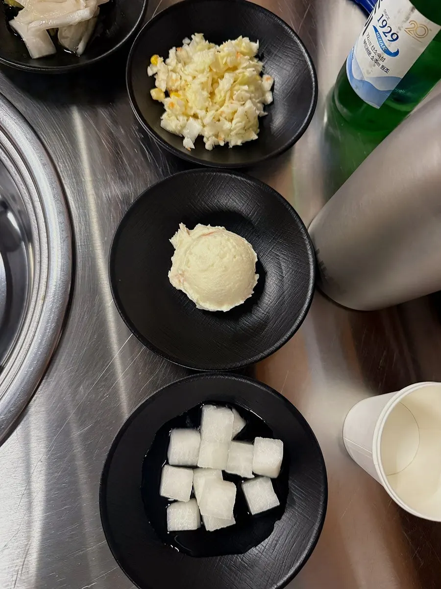 Table set with basic side dishes, white kimchi and pickled radish