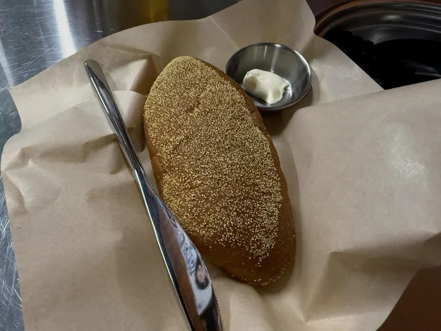 Spreading cream onto the Bushman bread