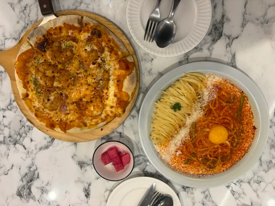 Pasta and pizza laid out on the table