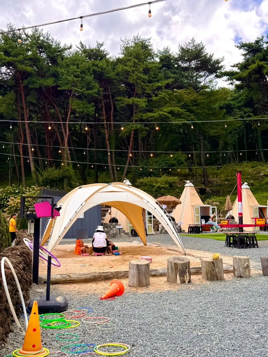 Trampoline and merry-go-round swing among the play facilities