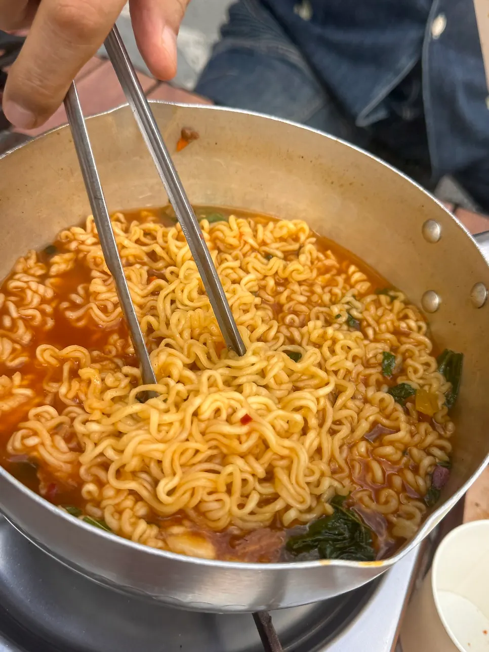 Spicy ramyeon eaten by the charcoal fire