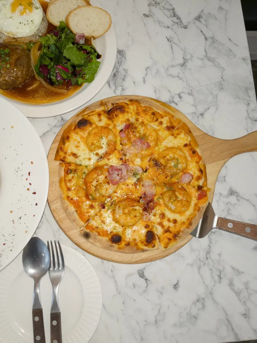 A slice of shrimp rosé pizza with stretching cheese