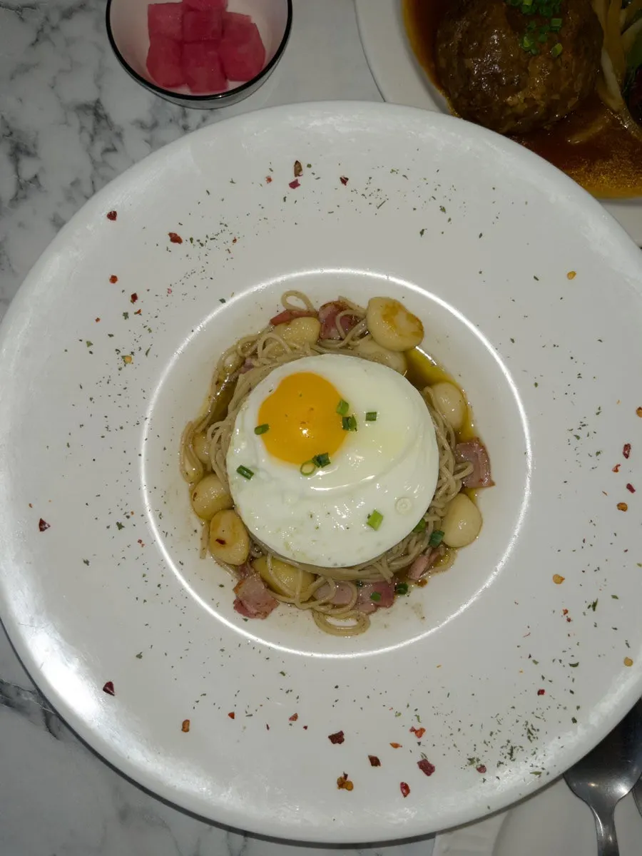 A plate of whole garlic bacon alio olio