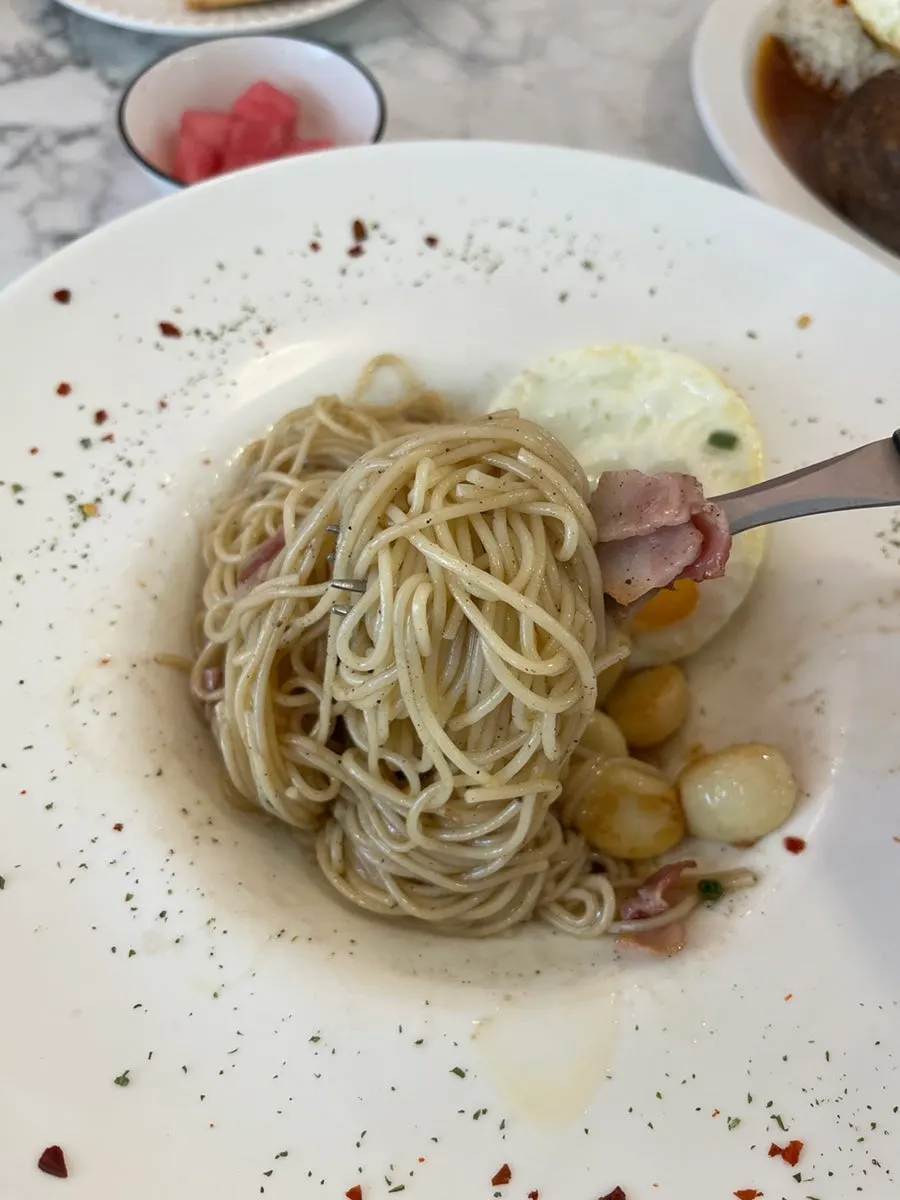 Capellini alio olio noodles lifted up on a fork